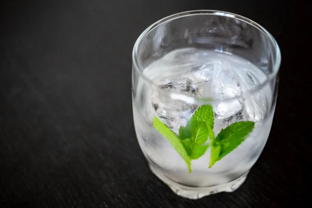 Shochu in a glass with ice and water and a couple of sprigs of mint.