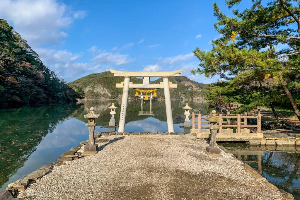 The Torii gate of Watatsumi Shrine on Tsushima Island overlooking the water.