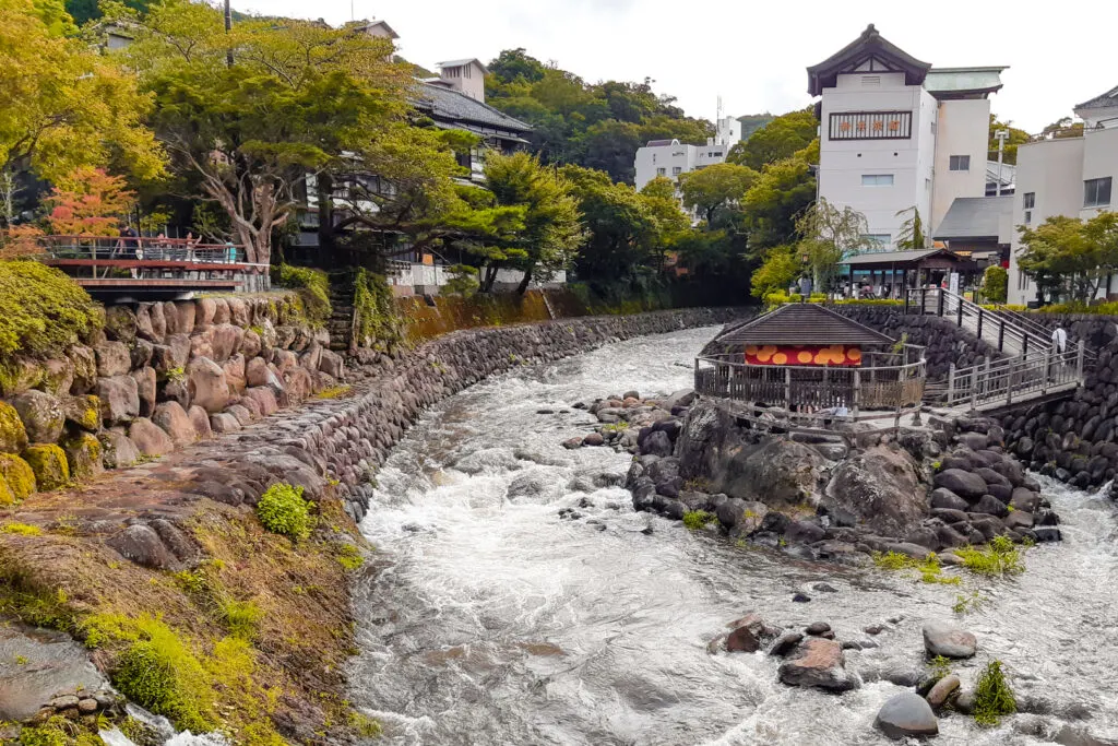 A view of the center of Shuzenji town with the Katsura River winding around the historic Tokko-no-Yu outdoor bath (no longer accessible to the public).