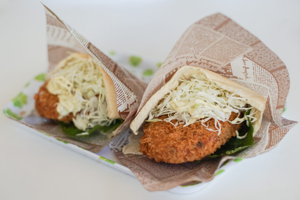 Two wasabi burgers from Daio Wasabi Farm. In little pockets of flat bread, there is a wasabi croquette, a wasabi leaf, cabbage and wasabi mayonnaise.
