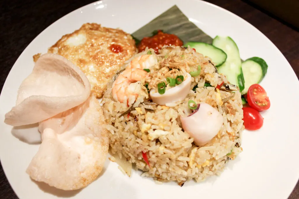 Halal restaurants in Tokyo - a plate of nasi goreng at Malay Asian Cuisine, fried rice with seafood plus egg, sambal, cucumber, cherry tomato and prawn crackers. 