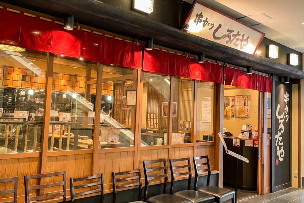 The wooden exterior of Kushikatsu Shirotaya - it has a simple traditional Japanese vibe that contrasts with the flashy facades of street-level restaurants along Dotonbori.