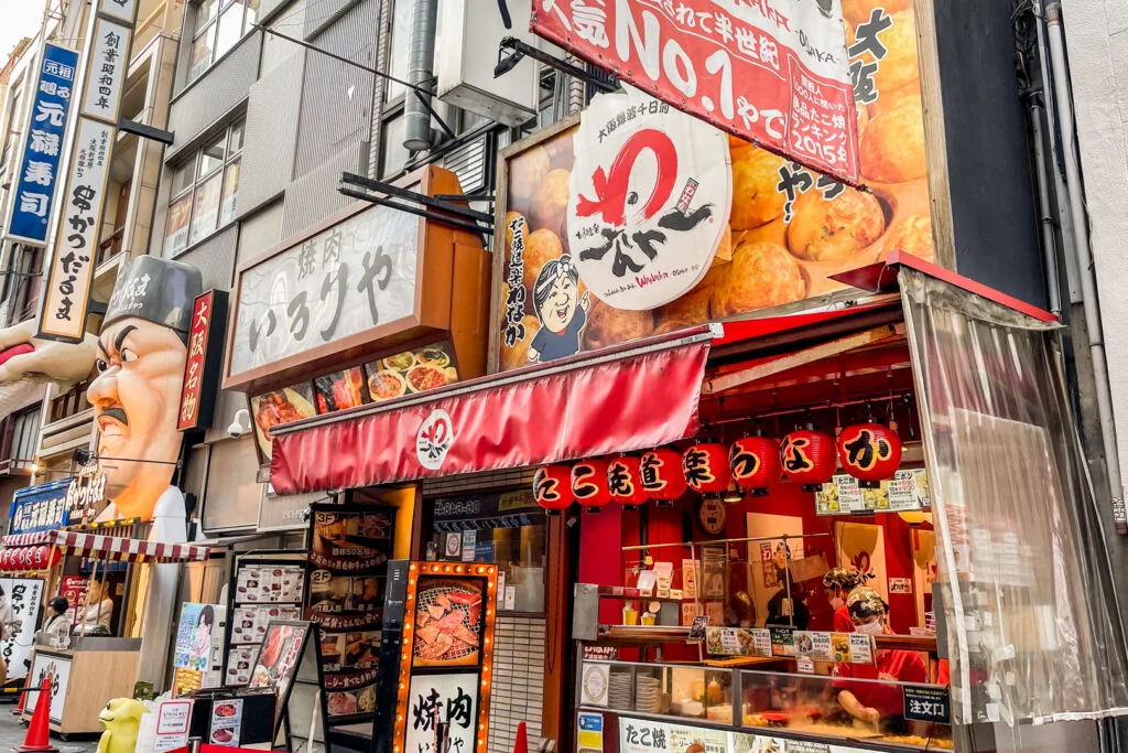 The outside of the Takoyaki Wanaka store with its red awning and red lanterns above the counter.