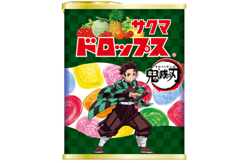 A steel tin of Sakuma Drops. The packaging has imagery of the hard candy, various fruits and an anime character.
