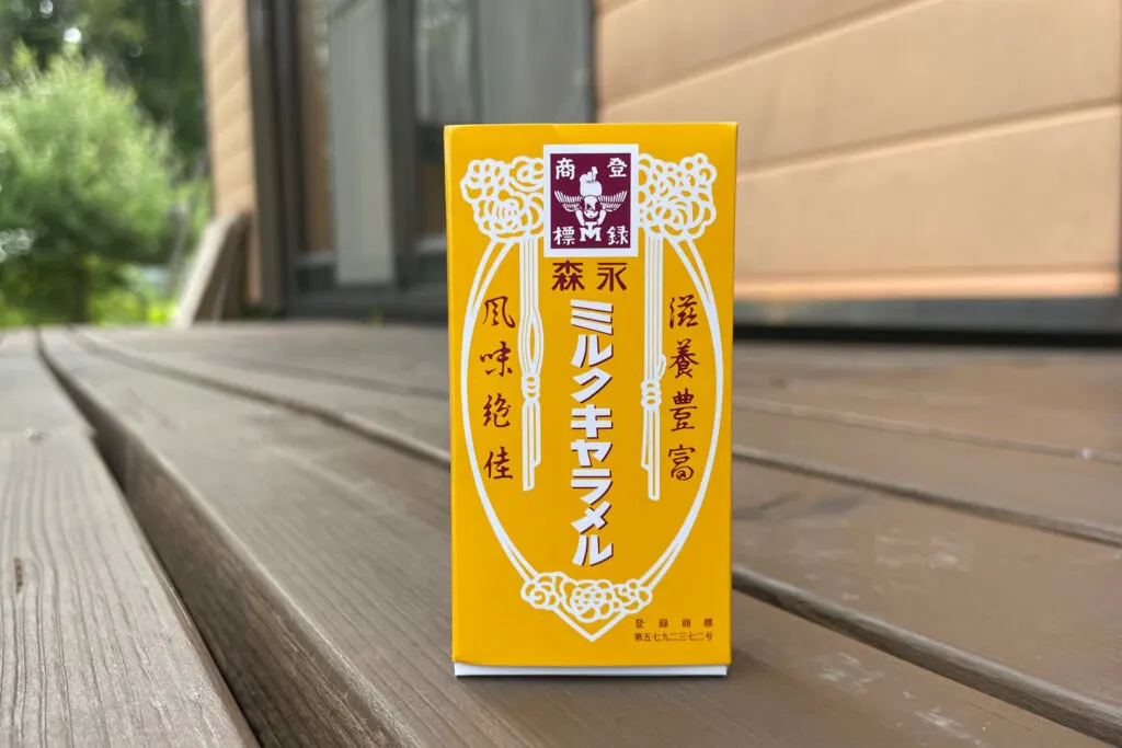 A box of Morinaga Milk Caramels. The box is golden yellow in color with white and maroon design/writing.
